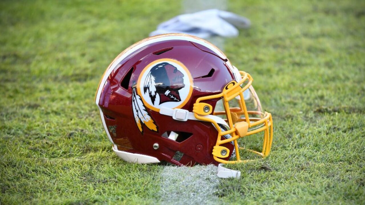 Norris Adams shows off his Washington Redskins football helmets in his home  in Charlotte, N.C. Since he was 9 years old, Adams put his name on the Washington  Redskins' season ticket list.